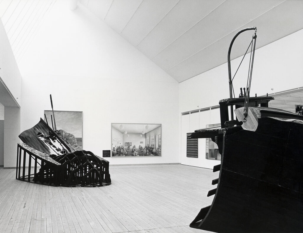 Black and white image with sculptures and paintings in the art gallery