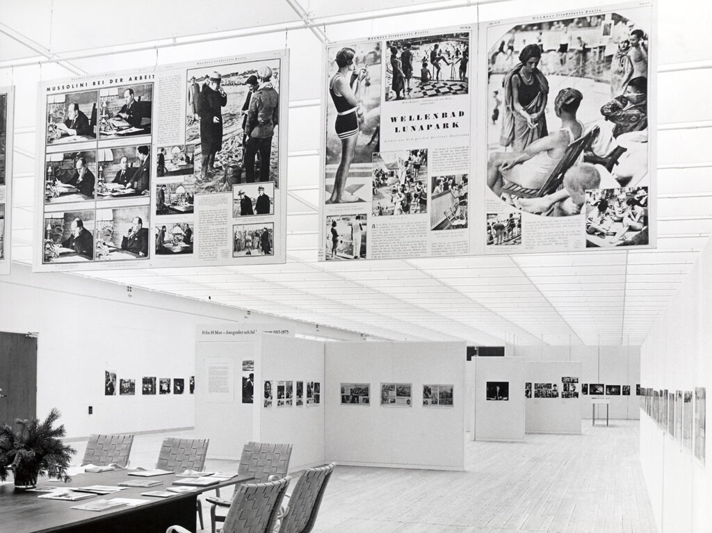 Black and white image of various works of art hanging on the walls in the art gallery.