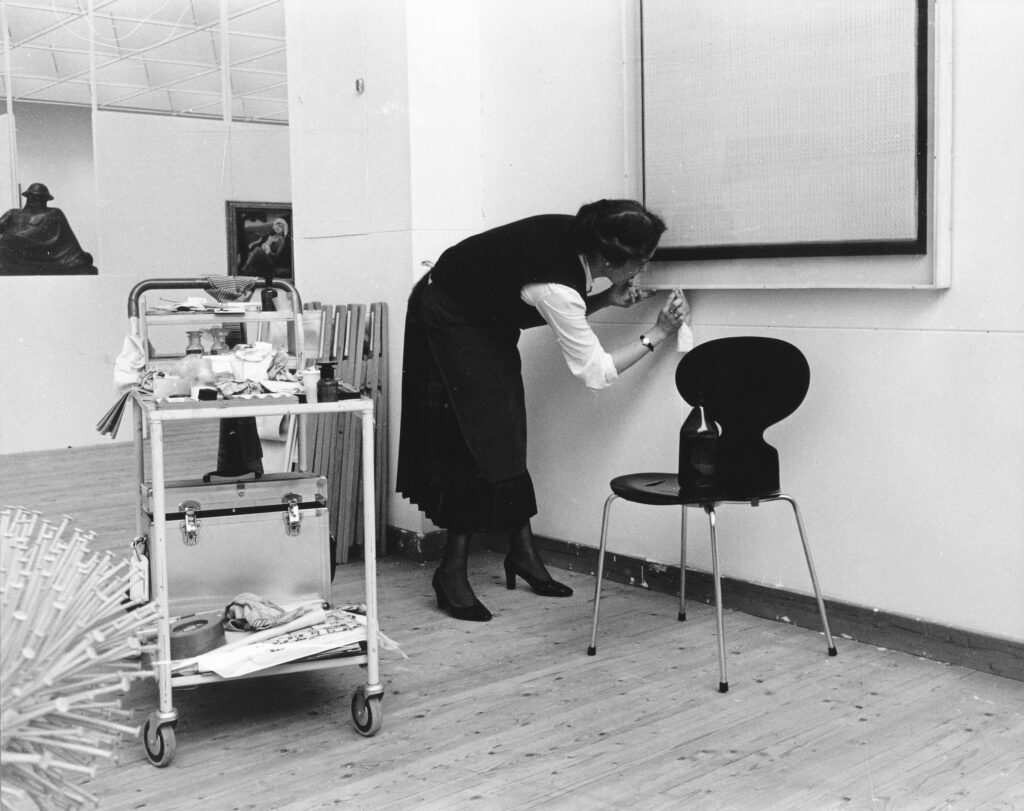 En kvinna står i en konsthall och