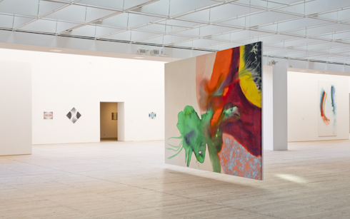 Ragna Bleys stora färgstarka, abstrakta målningar hänger i konsthallens ljusschakt.