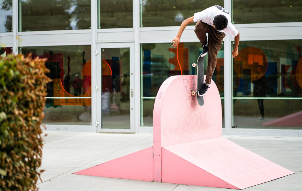 A skater on a pink ramp outside the gallery.