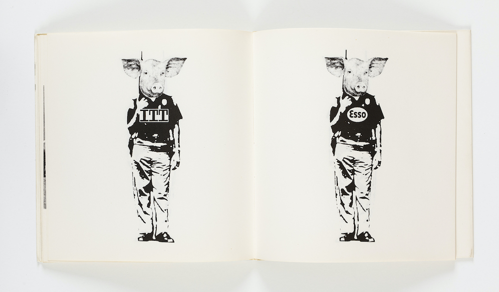 An open book with black and white collage by Åke Hodell, with human bodies in uniforms with pig heads.