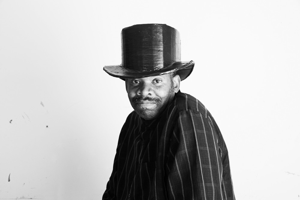 Black and white portrait of William Scott with a hand made top hat