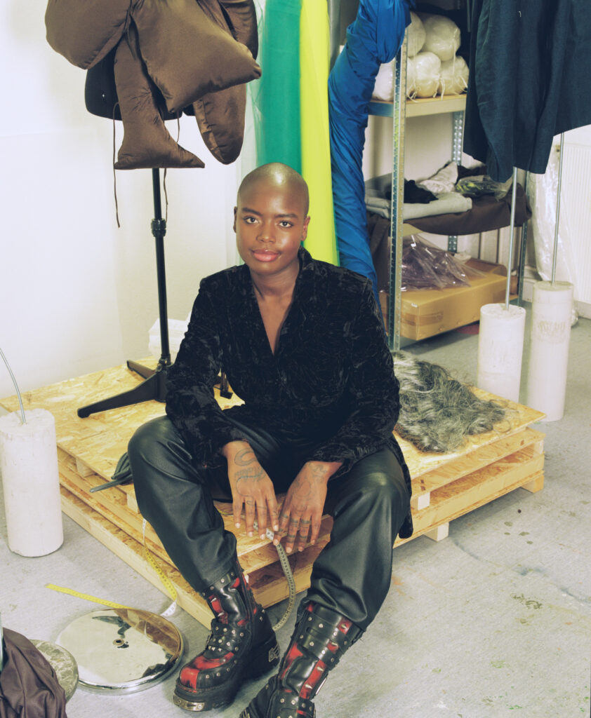 Color portrait of Sandra Mujinga in her studio.