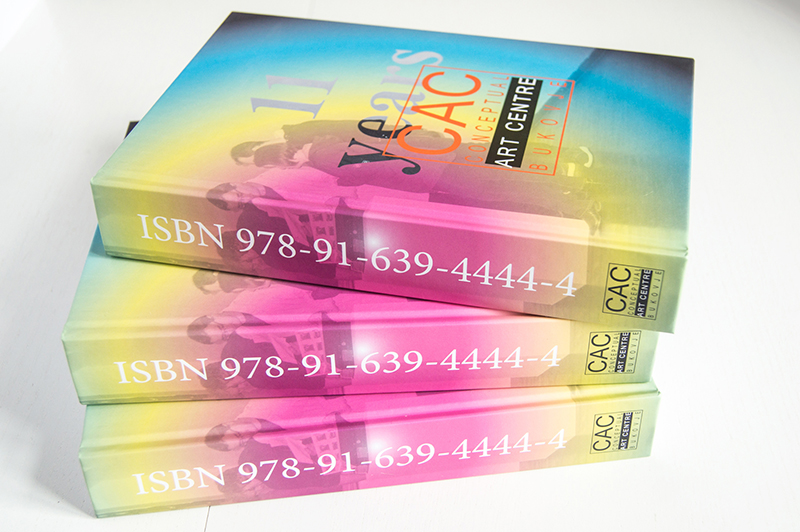 Three books in happy colors lie in a pile