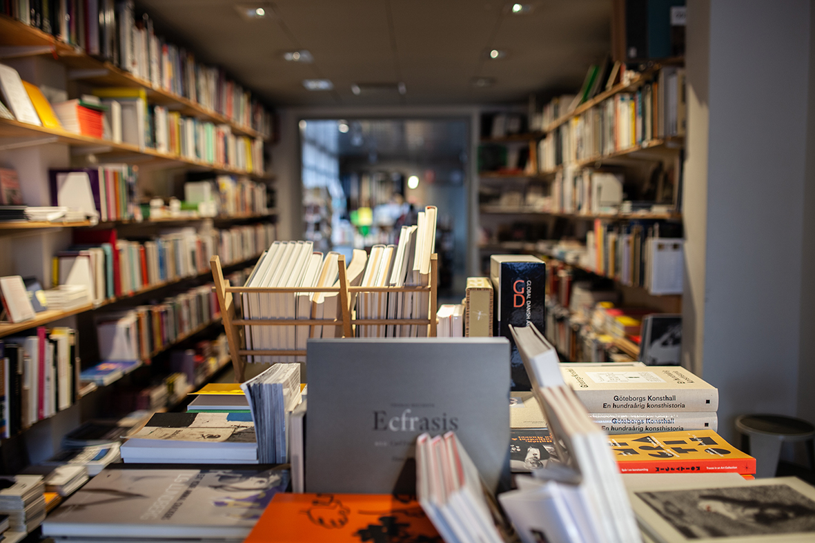 Illustration depicting a bookstore scene with a book table and an array of books and magazines.