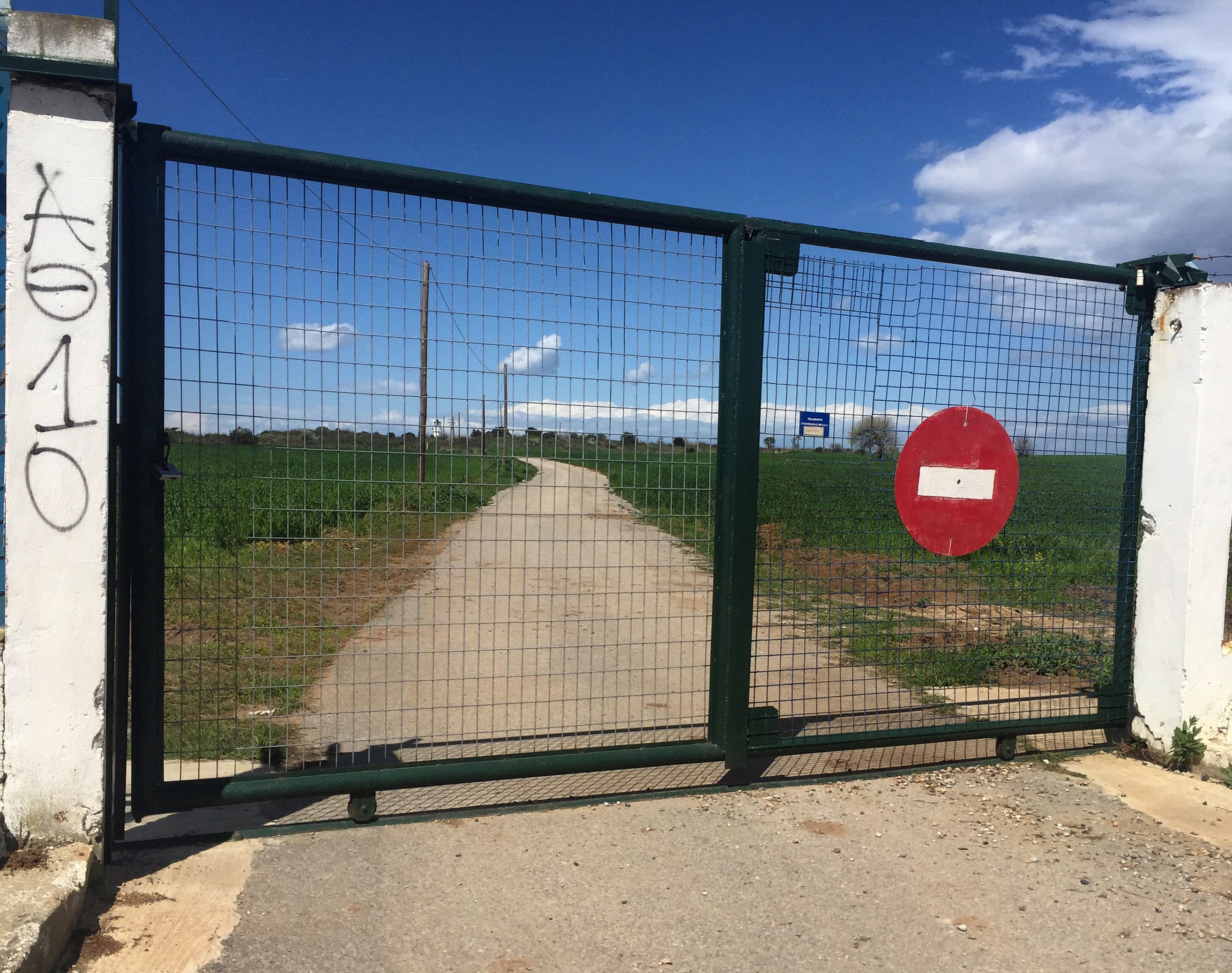 A fence with a sign indicating 'No Entry.' The image illustrates restrictions on freedom of speech and artistic expression.