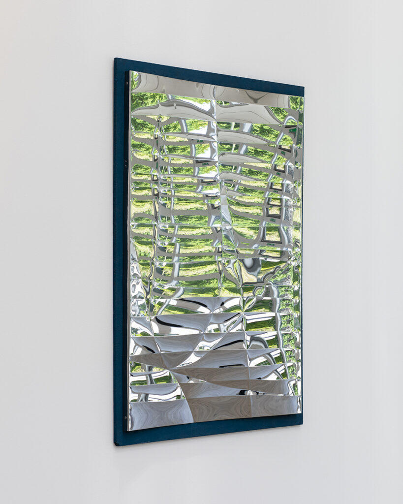 Work by Lars Fredrikson – framed metal mirror processed in an abstract pattern.