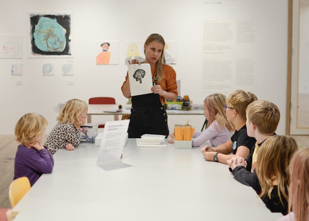 Miia Vallius leads a workshop in Verkstan with a group of children.