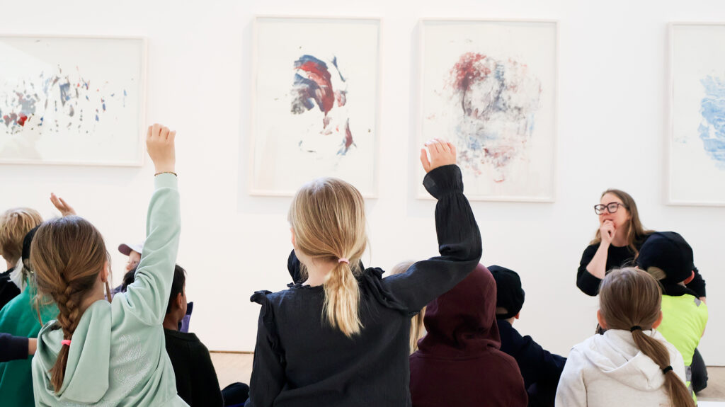 One of Malmö Konsthall’s educators is giving a guided tour for a preschool class in the exhibition hall.