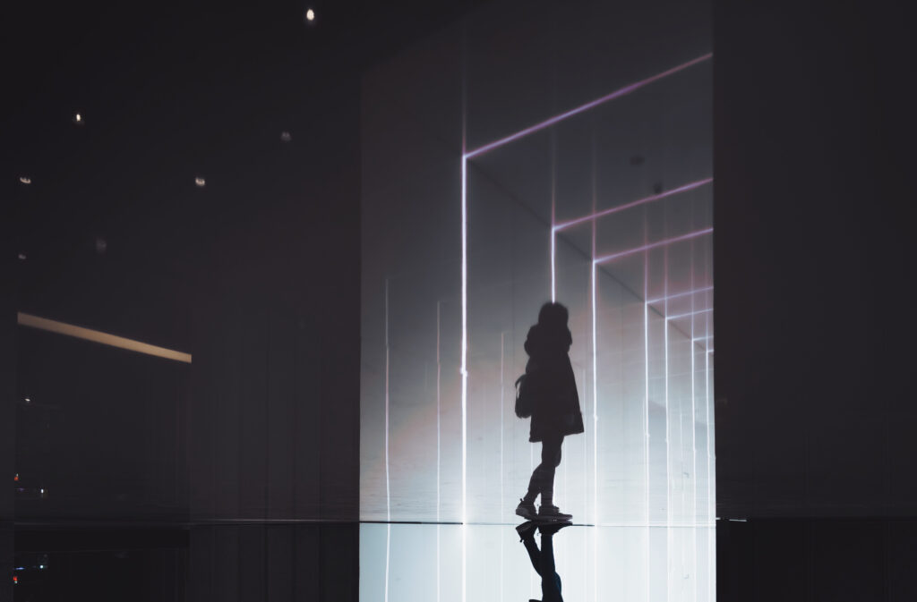 Digital image, silhouette of a young person walking away from the camera.